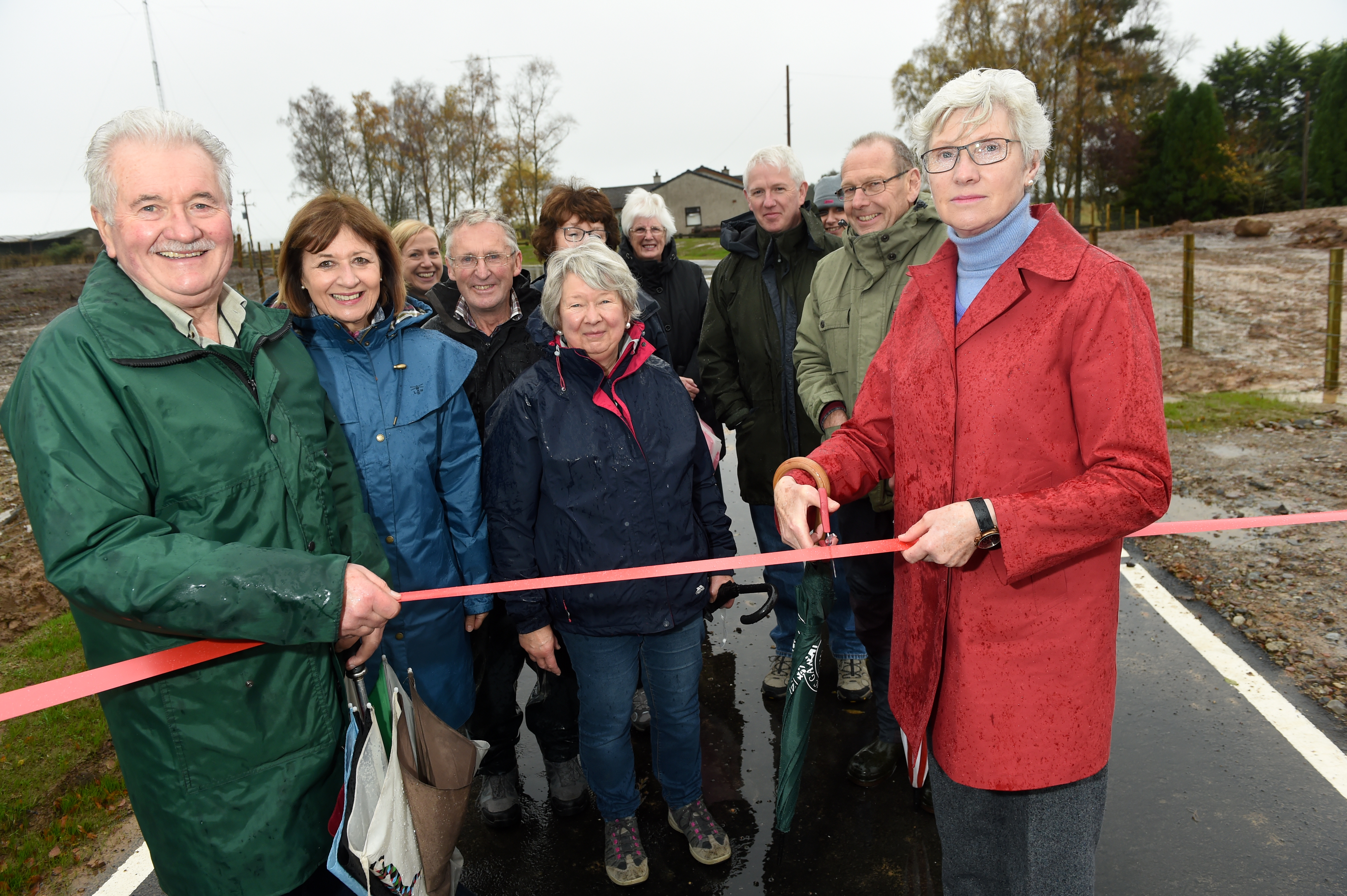 Former Highland Councillor Isobel McCallum cuts the ribbon to officially open the new junction. Also in the photograph are local campaigners who fought for the improvements. Picture by Sandy McCook