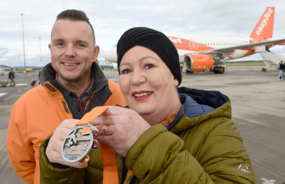 Andrew Benjamin of Maggies with Lorraine Fraser of Forres who raised the highest amount as an individual with £1900. Picture by Sandy McCook