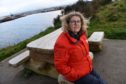 Caroline Snow, Merkinch Project Manager with one of the vandalised benches at Carnarc Point in Merkinch. Picture by Sandy McCook