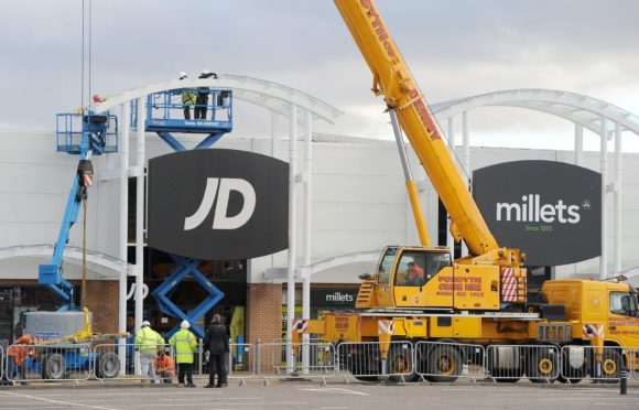 Work to remove glass panels from canopies above the walkway of the Inverness Business and Retail Park in 2017. Picture by Sandy McCook