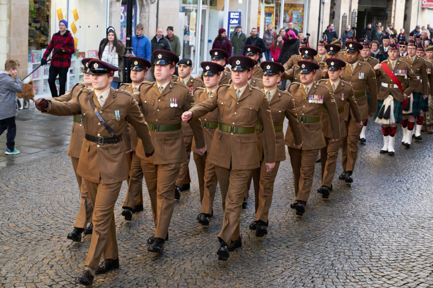 Forces march during Remembrance Sunday parade in Elgin