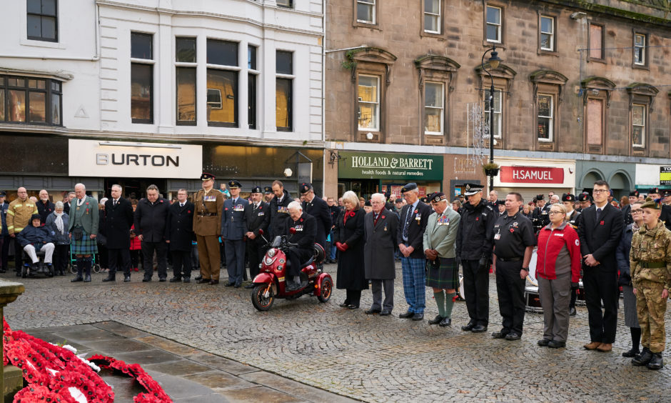 Members of the public pay their respects during the Remembrance Sunday service in Elgin