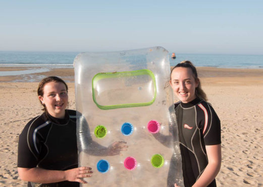 Isla and Eilidh Noble holding a lilo they used to save a man and a child.