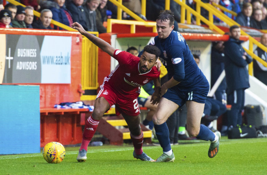 Aberdeen's Shay Logan (L) is pictured in action with Kilmarnock's Liam Miller during the Ladbrokes Premiership match between Aberdeen and Kilmarnock