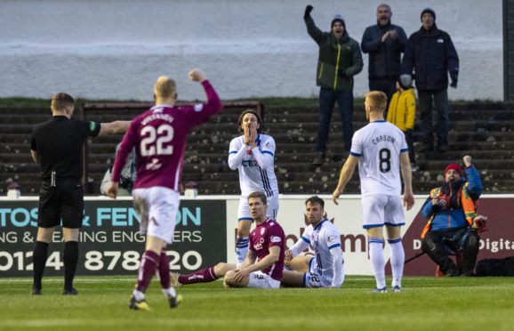 Brad McKay is penalised for his foul on Colin Hamilton.