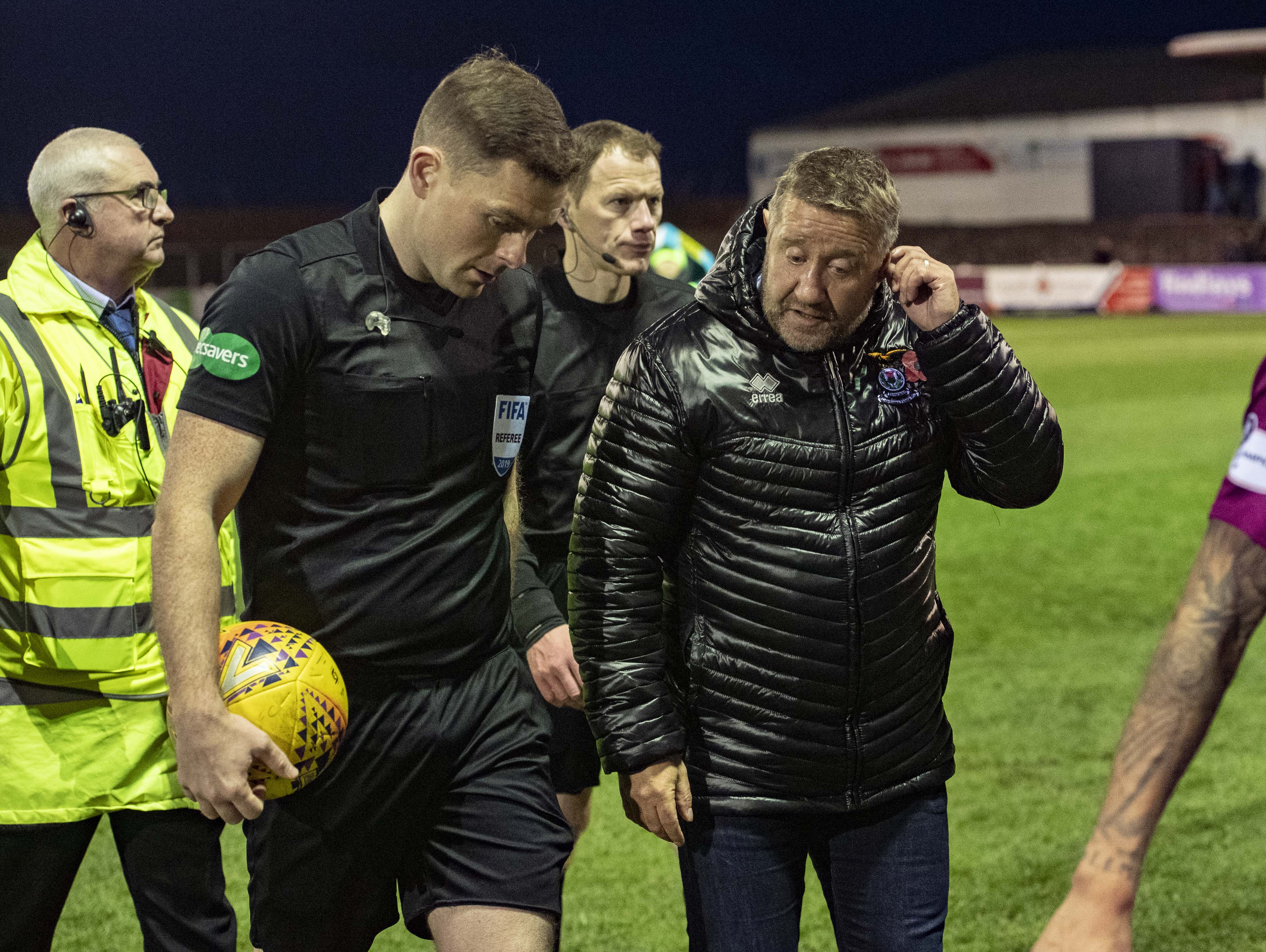 Inverness CT manager John Robertson (R) speaks with referee John Beaton at full-time.