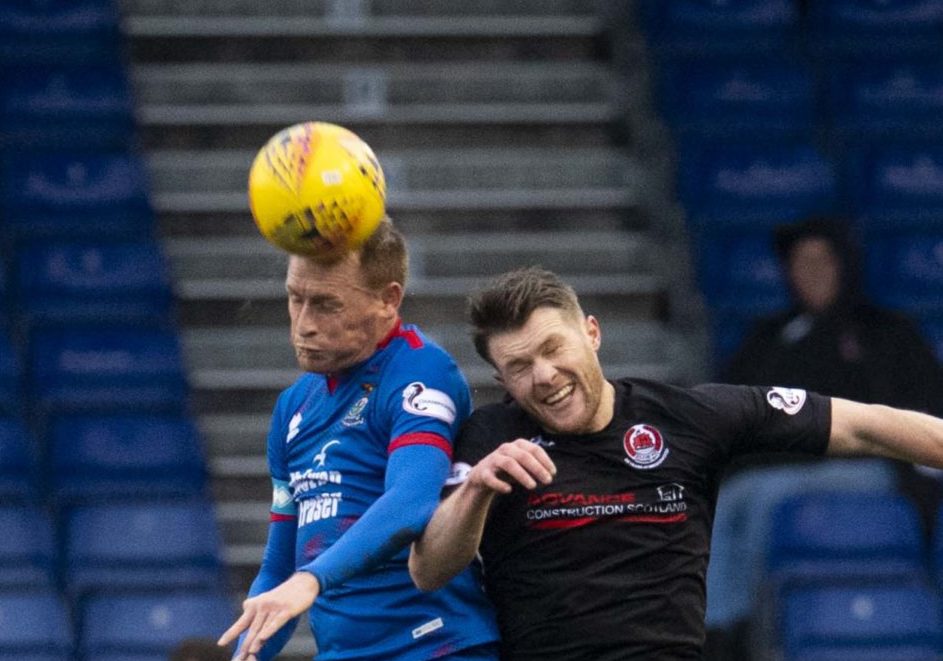 Inverness's Carl Tremarco (L) beats Clyde's Tony Wallace to the ball during the Tunnock's Caramel Wafer Challenge Cup Quarter Final match between Inverness CT and Clyde