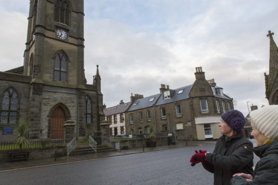 Dally Gunn (left) and Marelza McIvor double check the time shown on their wrist watches as Thurso's clock stands still.