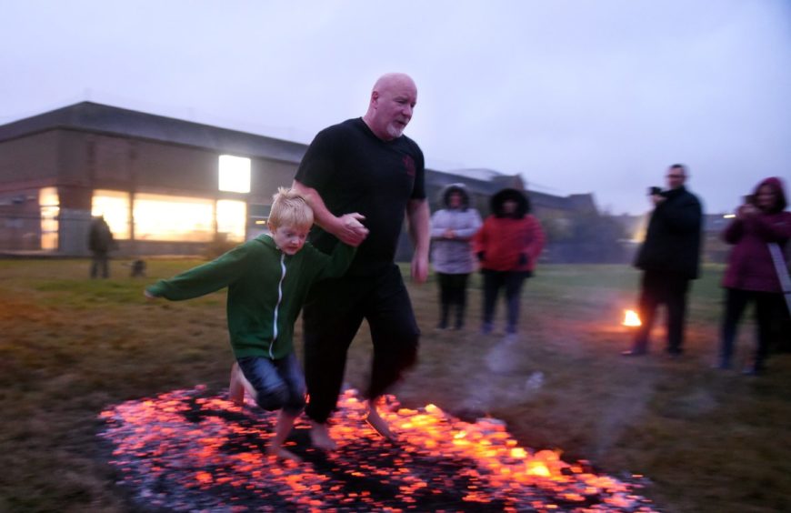 Eli Coutts, Peterhead, left  and Graeme Pyper, Aberdeen take on the fire walk. 
Picture by Jim Irvine