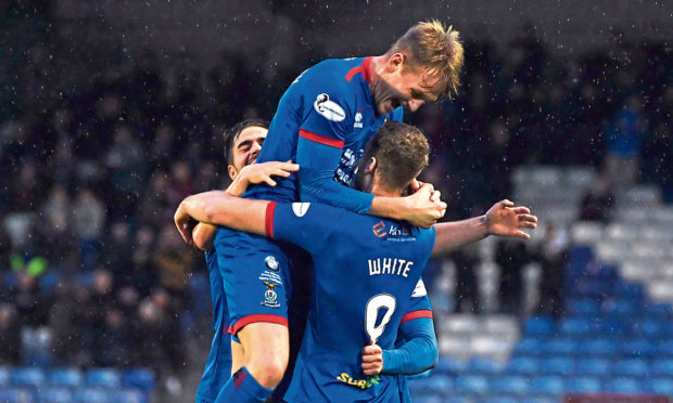 Jordan White celebrates his opener with teammates.