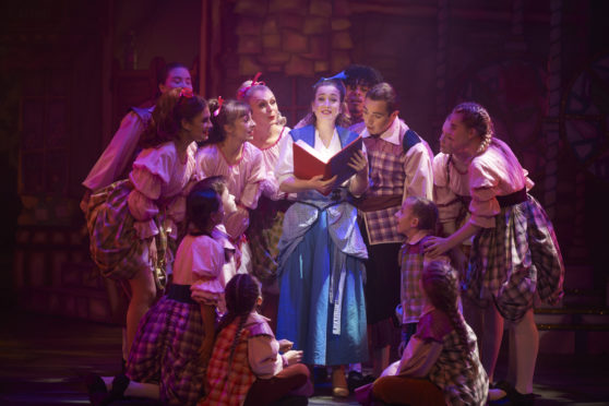 Belle, played by Christie Gowans, reads a story to the villagers.