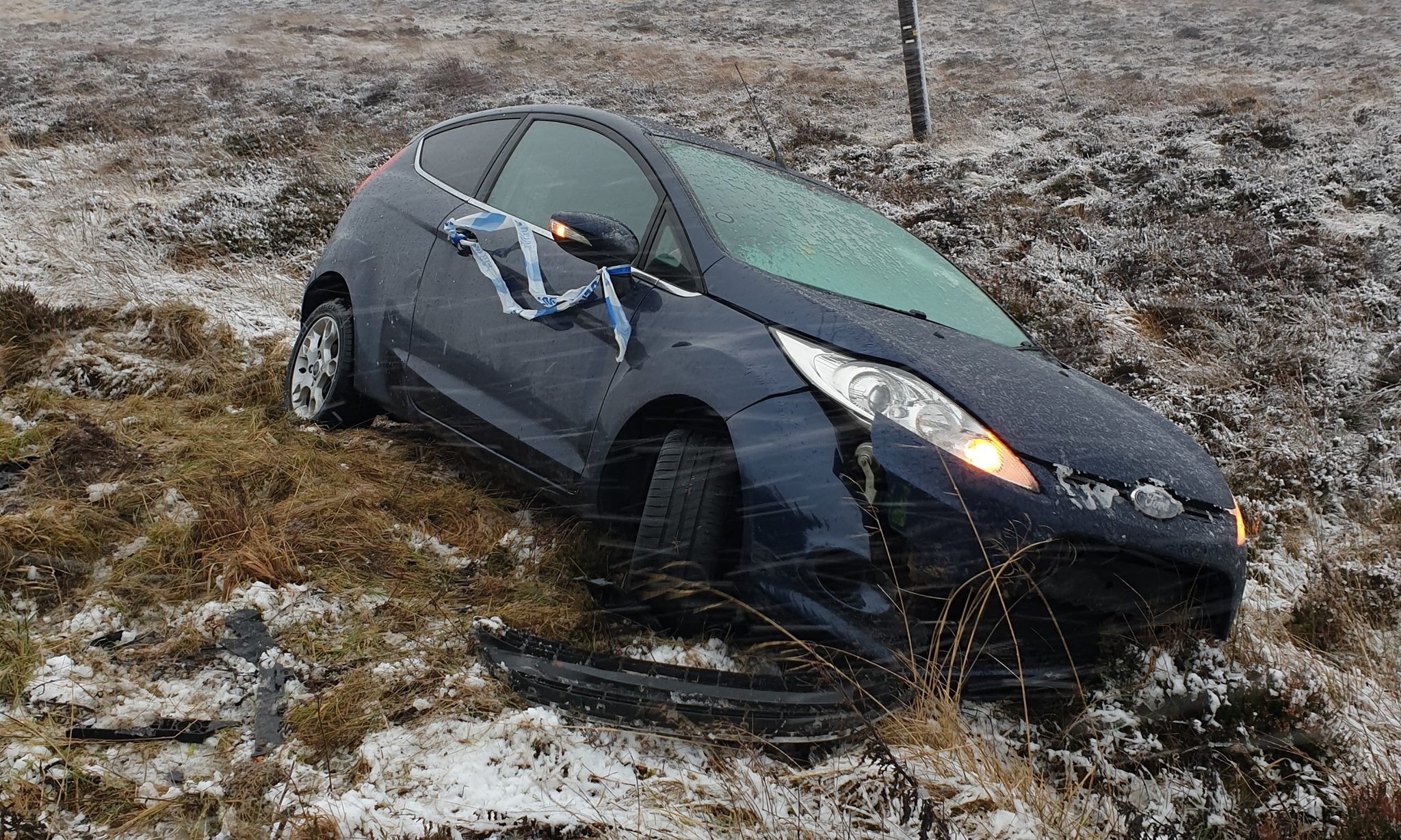 A car off the road following today's wintry conditions.
