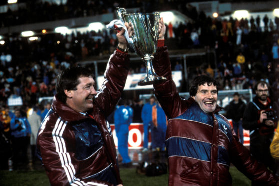 Aberdeen manager Alex Ferguson (left) and assistant Archie Knox celebrate with the trophy in Gothenburg in 1983.