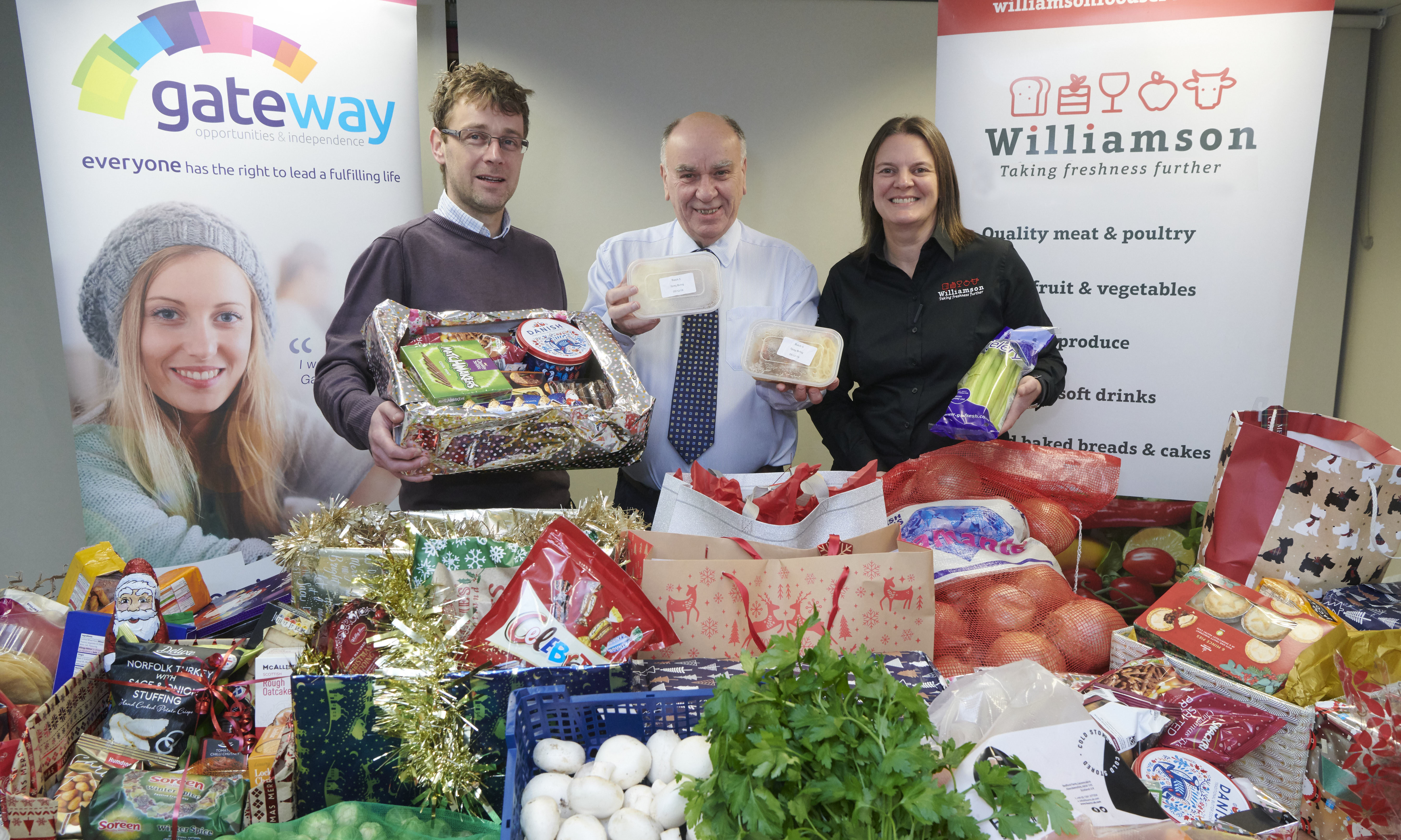 Craig Riddle, Gateway finance manager, David Sutherland, Food For Families founder, and Louise Beattie, sales manager for Williamson Foodservice with the food items ready for distribution