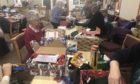Volunteers at Maryburgh Free Church sort through boxes to ensure they are appropriate