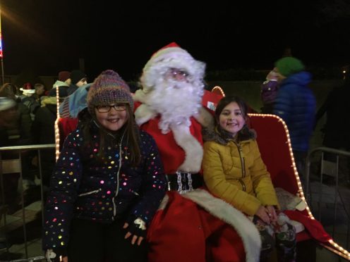 Emilee Hastie (left) and Jill Sinclair had the honour of switching on Nairn's Christmas lights with Santa.