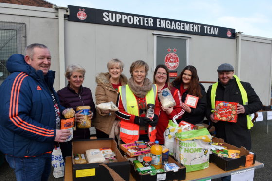 Organiser Aleen Shinnie at centre with some the other volunteers helping at the collection point

Picture by Paul Glendell