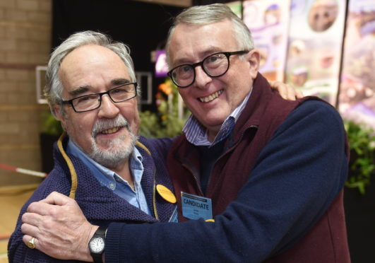 Liberal Democrats Jamie Stone (right) celebrates after being re-elected for the Caithness, Sutherland and Easter Ross seat at Inverness Sports Centre. Picture by Sandy McCook