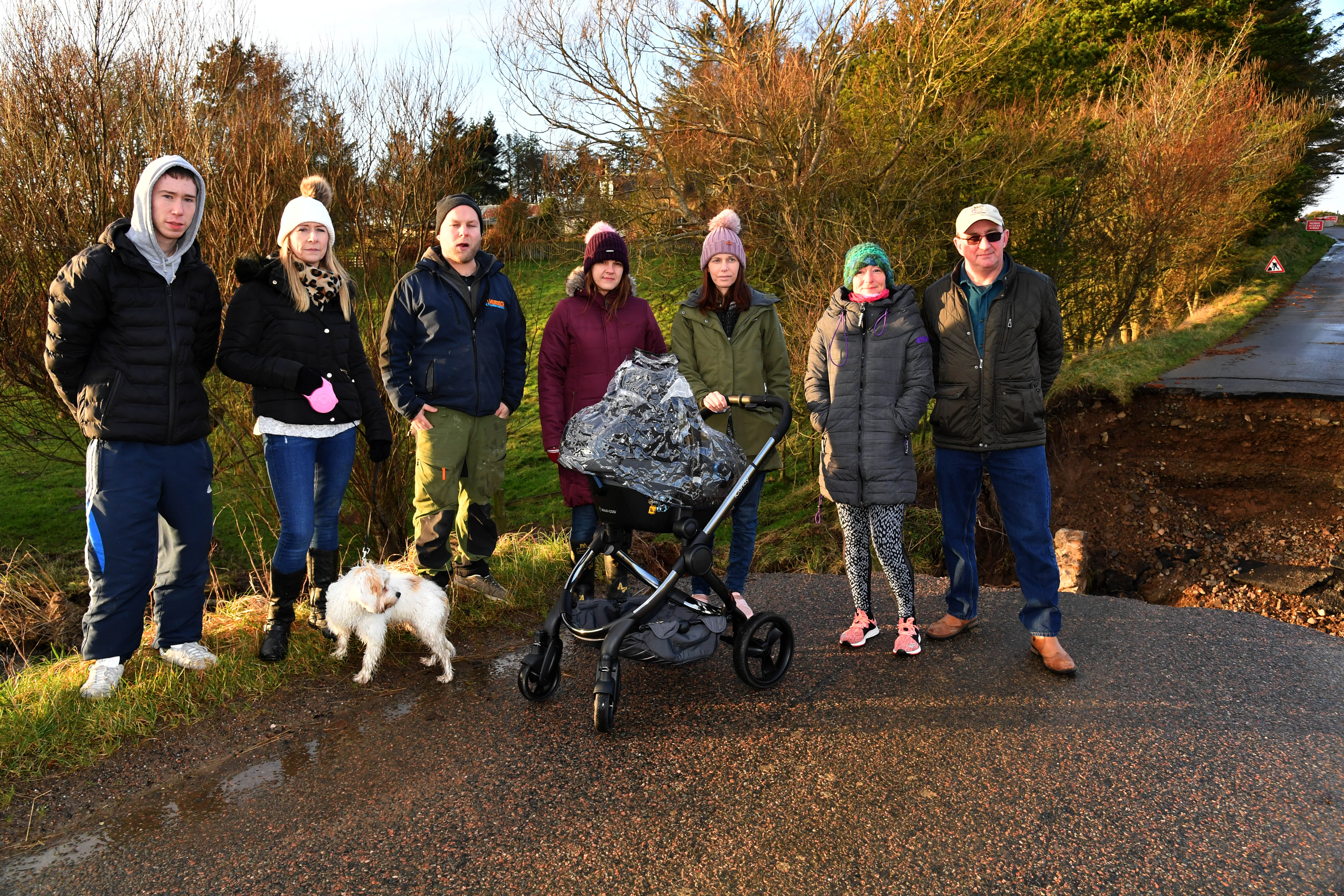 L-R: Andrew Farquhar, Nicola Farquhar, Euan Murdoch, Lynne Duncan, Helen Wilson, Sam Philip And Cliff Pirie at one of the four bridges at King Edward which was swept away in September and nothing has been done about it.