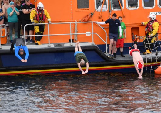 Swimmers brave the low temperature for the Boxing Day swim across Fraserburgh harbour in aid of the RNLI.