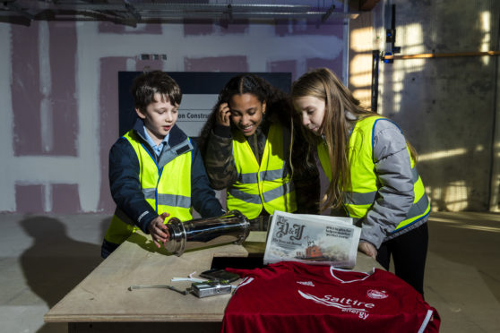 Children fill the time capsule 
(Photo by Ross Johnston/Newsline Media)