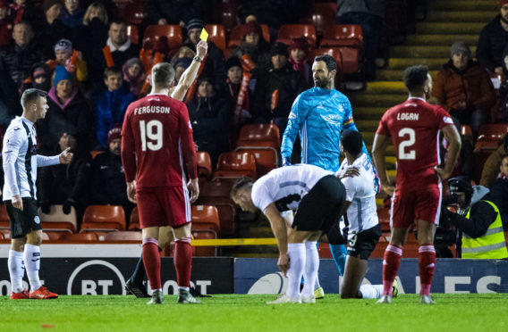 Aberdeen's Joe Lewis is booked by referee Steven McLean during the Ladbrokes Premiership match between Aberdeen and St Mirren at Pittodrie.