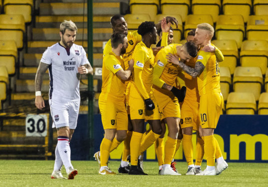 Lyndon Dykes is mobbed by his Livingston team-mates en-route to his hat-trick against Ross County.
