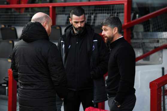Ross County Co-managers Steven Ferguson (L) and Stuart Kettlewell chat with Motherwell Manager Stephen Robinson (R) before the Ladbrokes Premiership match between Ross County and Motherwell at the Global Energy Stadium, on December 26, 2019, in Dingwall, Scotland.