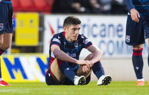 Ross County's Ross Stewart (centre) goes down injured during a Ladbrokes Premiership match between St Johnstone and Ross County.