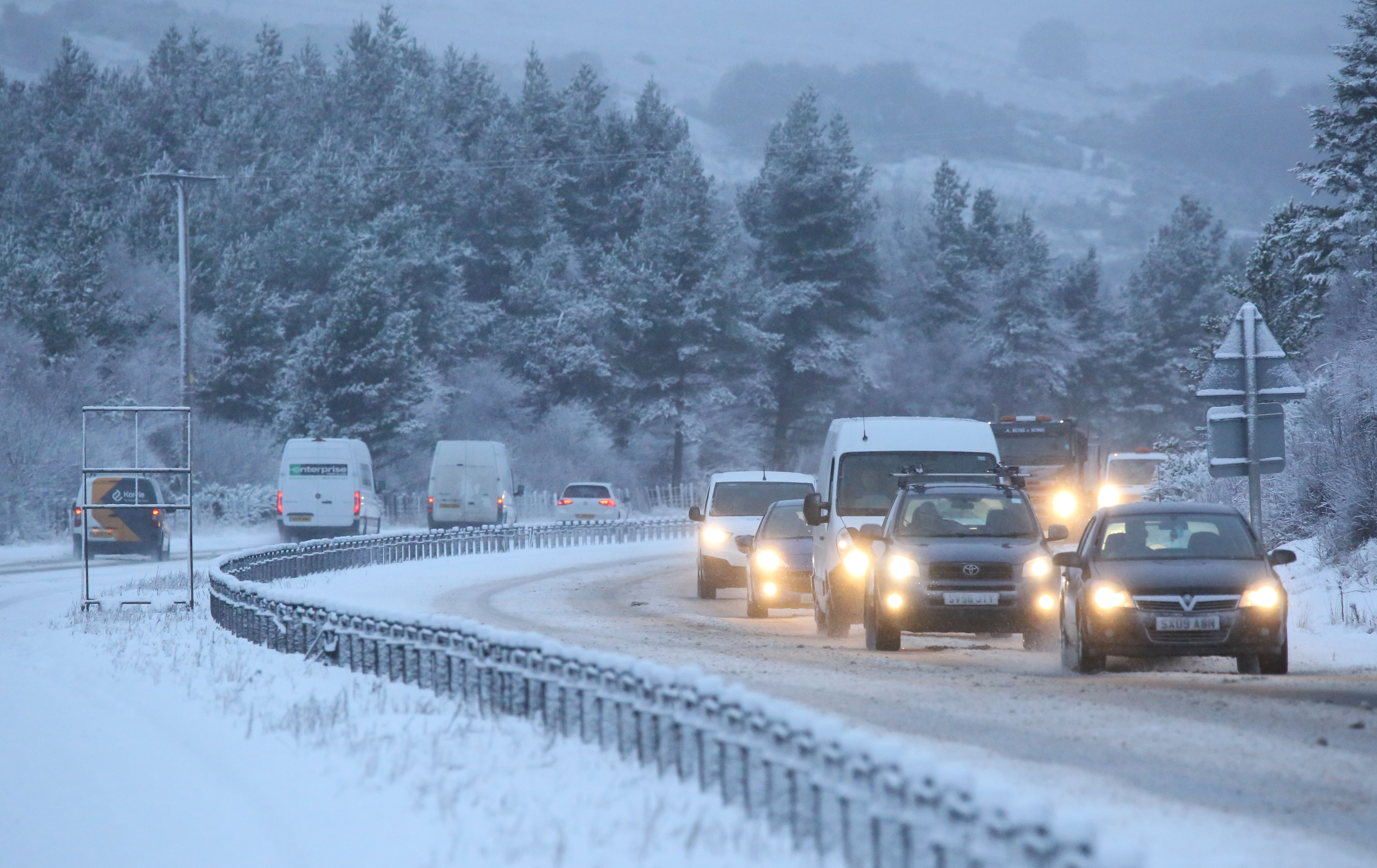 Traffic on the A9 near Inverness as heavy snow falls across the Highlands.