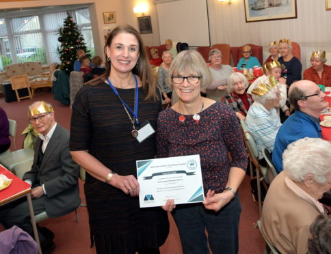 Val receives her award from Sandra McGuigan