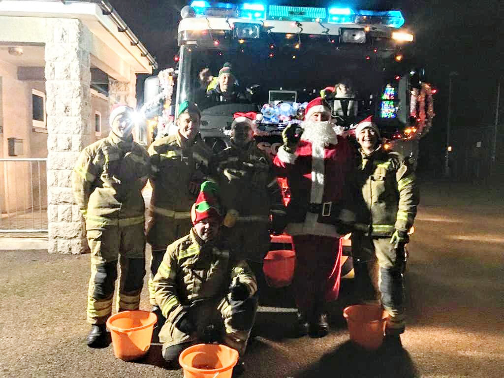 Portsoy Fire crew with their decorated engine and Santa