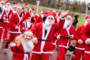 Runners dressed as Santa take part in a Santa Fun Run at the Inverness Campus.