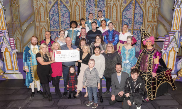 Donald Mathieson with the £4000 cheque presented to Mary Nimmo and Archie Highland fundraiser Dawn Cowie, alongside friends, family and cast members.