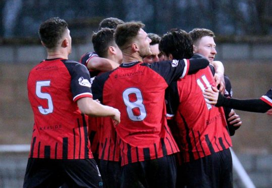 Elgin's second goalscorer Kane Hester hidden amongst celebrating team-mates.