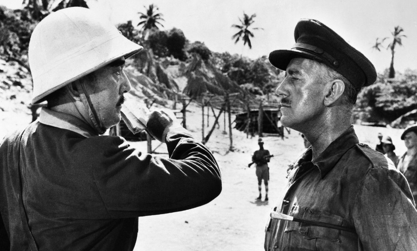 Colonel Saito (Sessue Hayakawa) faces off with Lieutenant Colonel Nicholson (Alec Guinness), the embodiment of the stiff upper lip, in the 1957 film The Bridge Over The River Kwai.