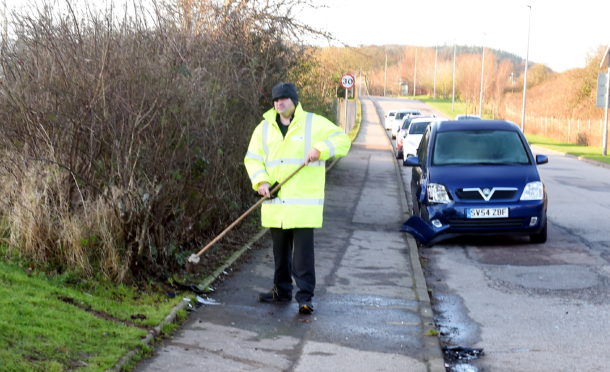 Efforts were taken to clear up debris from the road after the crash on Forest Drive.