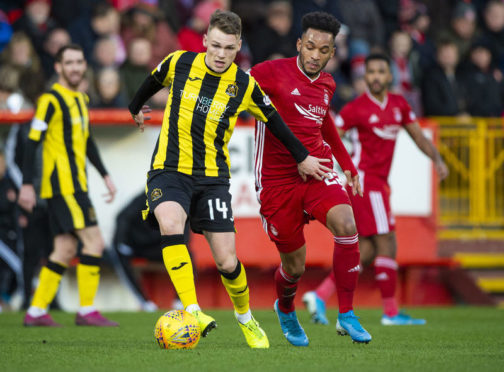 Aberdeen’s Funso Ojo and Dumbarton’s Joe McKee in action during the William Hill Scottish Cup 4th round tie between Aberdeen and Dumbarton. (Photo by Bill Murray / SNS Group)