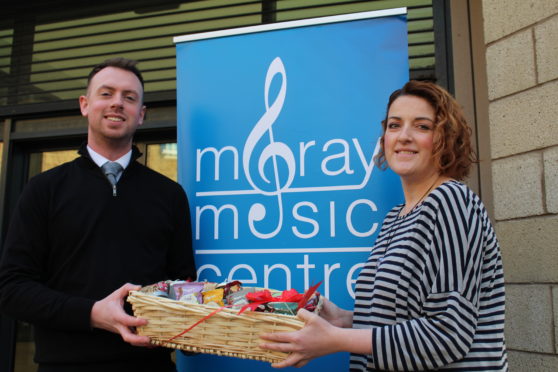 Moray Council's acting head of music instruction service Alexander Davidson and Moray Food Plus' volunteer development officer Gillian Pirie.