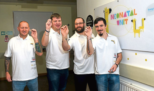 Four pals broke a Guinness World Record for the longest doubles darts match. 
Pictured from left, Mark Taylor, Neil Munro , Dave Matthew and Lewis Grant.