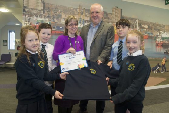 Monica Malet, chief executive of Scottish Fairtrade Forum Martin Rhodes and St Joseph pupils in their sustainable uniforms