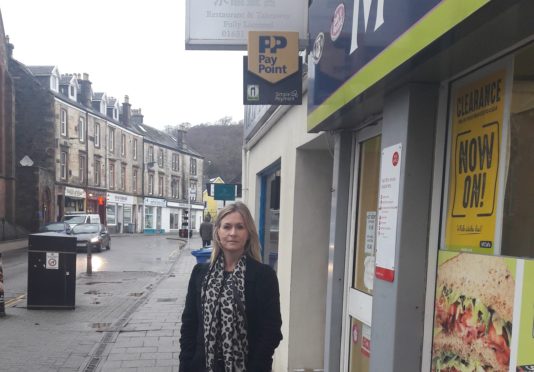 Councillor Julie McKenzie outside the McColls shop in George Street which sells electricity