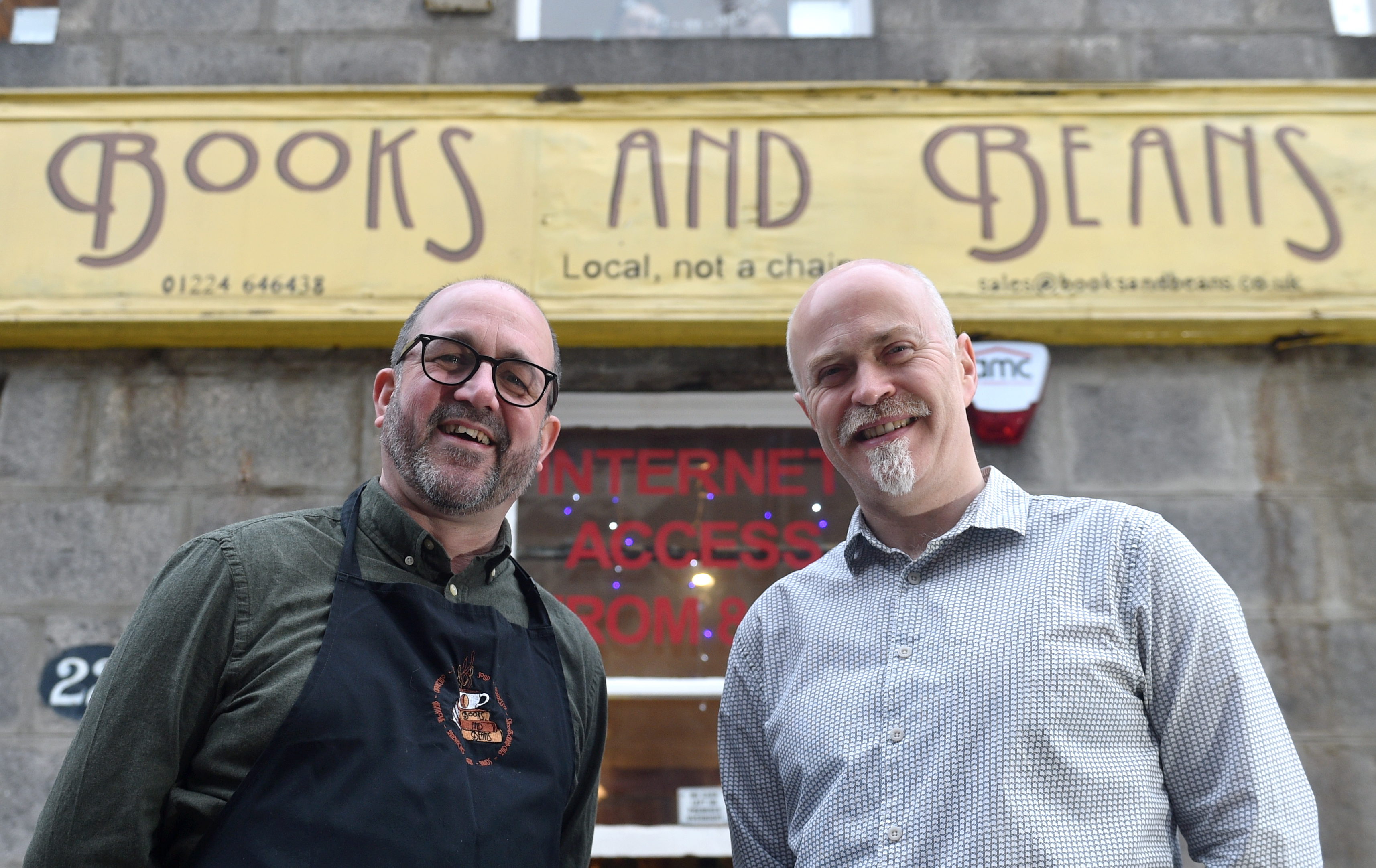 New owner John Wigglesworth and former owner Craig Willox outside Books and Beans. Picture by Darrell Benns