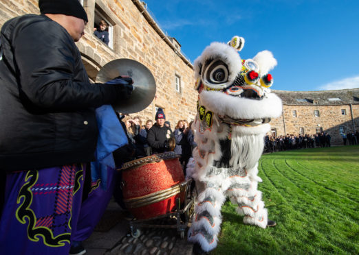 Lion dancing group Glasgow Hong Lok Dragon and Lion Dance Troupe perform for pupils and staff at Gordonstoun School in the Round Square.