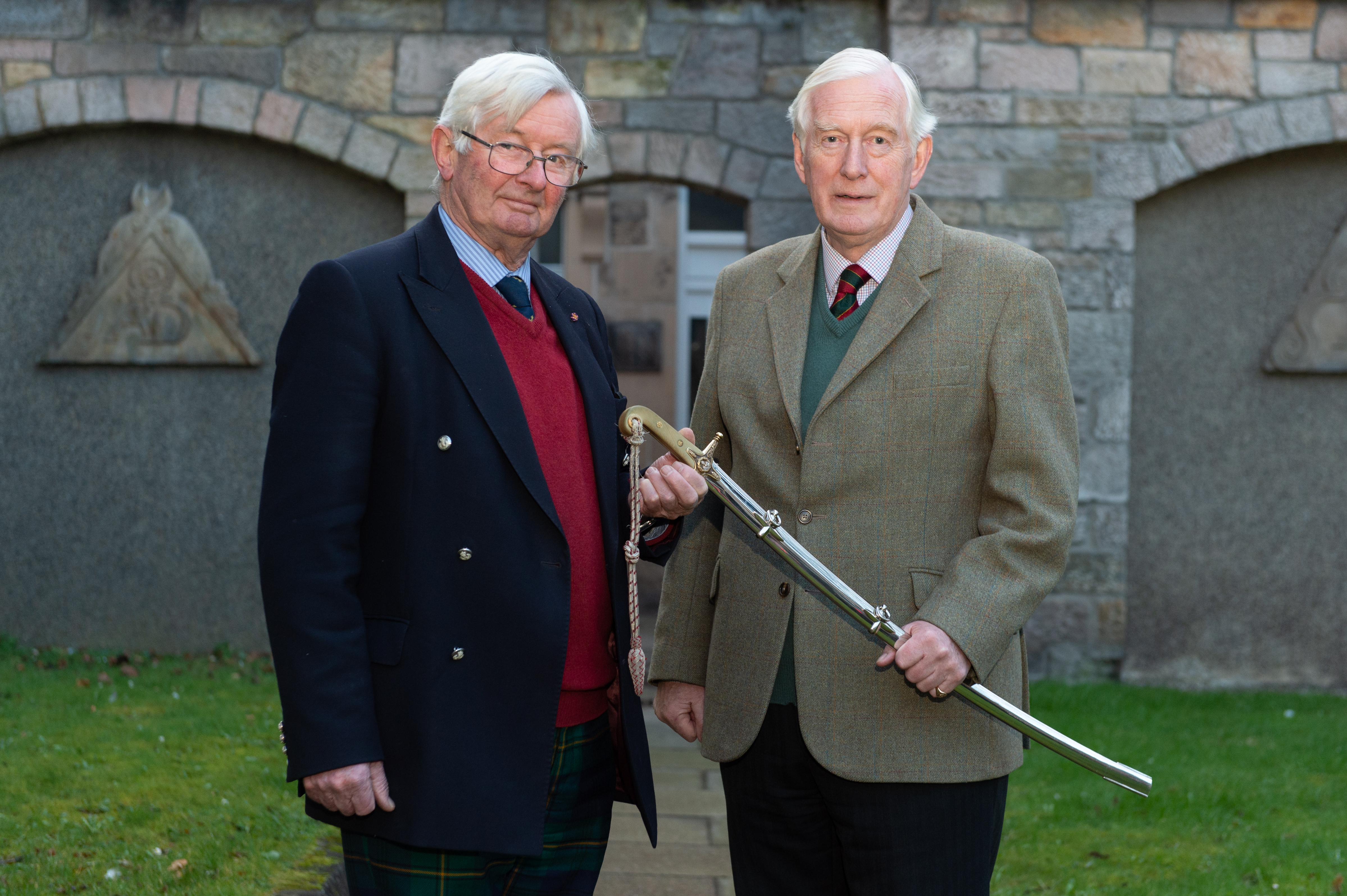 Former lord lieutenant Grenville Johnston passes the sword of office to new appointee Seymour Monro.