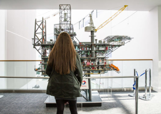 FOI figures show applications for oil and gas courses are making a comeback following a steep drop. Pictured: A student stands in front of a replica of the Alwyn North platform at RGU's Sir Ian Wood building. Credit: RGU.