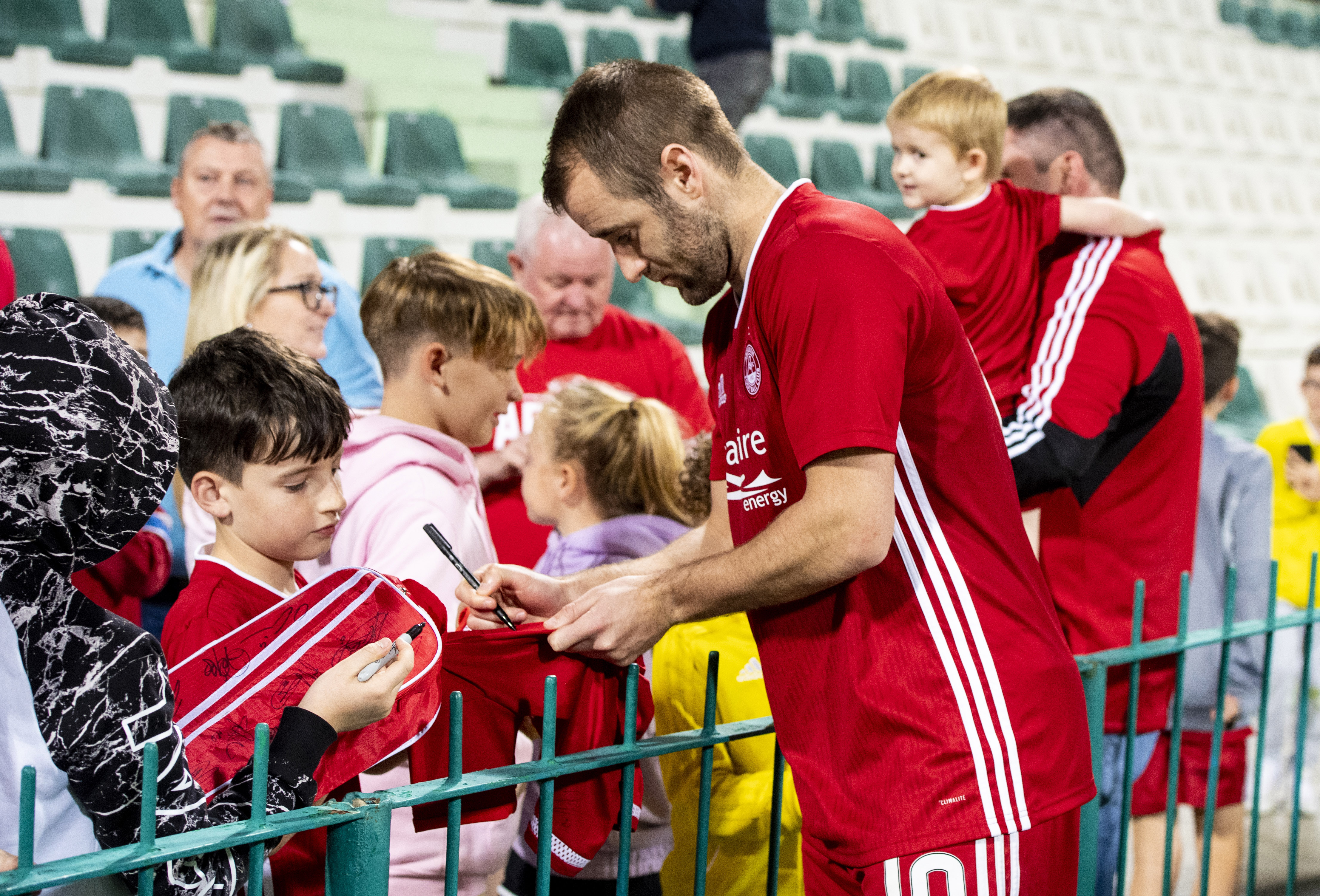 Niall McGinn signs autographs after the friendly with Al Wehdat in Dubai.