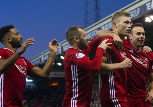 Aberdeen's Sam Cosgrove celebrates with teammates during the William Hill Scottish Cup 4th round tie between Aberdeen and Dumbarton