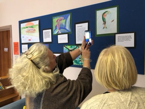 Members of the River Dee Trust judging the children's artwork