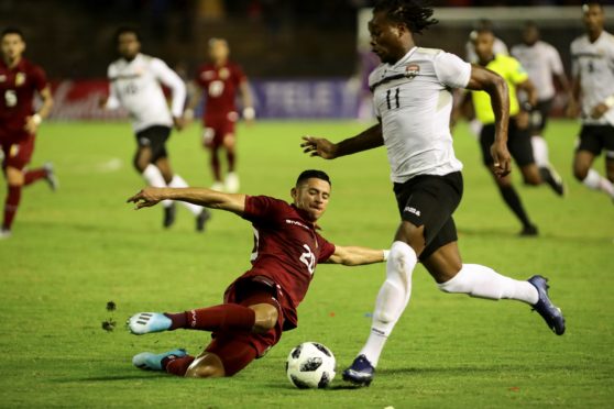 Venezuela's Ronald Hernandez (L) vies for the ball with Trinidad and Tobago's Levi Garcia (R) during a friendly.